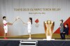 An ignition ceremony for the Tokyo Olympic torch relay is held at Heiwadai Athletic Stadium in Fukuoka, southwestern Japan, Tuesday, May 11, 2021. The torch relay was taken off public roads due to the coronavirus pandemic. The next week's torch relay is being pulled off the streets in Hiroshima prefecture, too, as COVID-19 cases rise in Japan. This is at least the sixth change to the relay - from rerouting to cancellation - in the last several weeks as cases surge in Japan. Organizers warned before the relay began that changes and delays were expected in the face of the pandemic. (Kyodo News via AP)