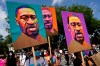 People carry posters with George Floyd on them as they march from the Lincoln Memorial to the Martin Luther King Jr. Memorial in Washington. As the anniversary of George Floyd’s murder approaches, some people say the best way to honor him is for Congress to pass a bill in his name that overhauls policing. (Carolyn Kaster / The Associated Press files)