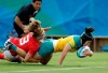 FILE - In this Aug. 8, 2016, file photo, Australia's Emilee Cherry, right, scores a try as Canada's Karen Paquin, defends during the women's rugby sevens semi final match at the Summer Olympics in Rio de Janeiro, Brazil. Cherry, the former women's sevens player of the year who gave birth to a daughter in 2019 announced Friday, May 28, 2021, that she's retiring and won't be in the Australian team when the Tokyo Olympic Games begin on July 23. (AP Photo/Themba Hadebe, File)