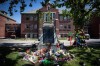 Flowers and cards are left at a makeshift memorial at a monument outside the former Kamloops Indian Residential School, to honour the 215 children whose remains have been discovered buried near the facility, in Kamloops, B.C., on Monday, May 31, 2021. THE CANADIAN PRESS/Darryl Dyck