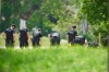 A line of police officers look for evidence at the scene of a car crash in London, Ont., Monday, June 7, 2021. The National Council of Canadian Muslims says it is “beyond horrified” by the vehicle attack, which killed four members of a family in London, Ont., Sunday. THE CANADIAN PRESS/Geoff Robins