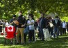 A man works on his laptop as thousands of people wait over six hours for their COVID-19 vaccine at a pop-up mass vaccination clinic at Jimmie Simpson Recreation Centre during the COVID-19 pandemic in Toronto on Thursday, June 17, 2021. THE CANADIAN PRESS/Nathan Denette