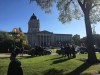 Politicians, staff and visitors are seen outside the Manitoba legislature in Winnipeg after it was evacuated due to a security threat on Oct. 5, 2017. THE CANADIAN PRESS/Steve Lambert