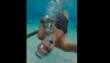 This is a Feb. 5, 2019 photo provided by Olympic swimmer Erin Gallagher of her swimming under water in Durban, South Africa. Gallagher got COVID-19 late last year and went from elite Olympic athlete in peak condition to lying flat on a bed concentrating on just breathing. And yet she's one of the lucky ones. She recovered and is going to Tokyo. Other African hopefuls have not been so fortunate as the coronavirus surges again across the continent just as the Olympics approach. (Erin Gallagher via AP)