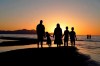 FILE - In this June 13, 2021 file photo, people hold hands as they gather at the receding edge of the Great Salt Lake to watch the sunset near Salt Lake City. The lake has been shrinking for years, and a drought gripping the American West could make this year the worst yet. (AP Photo/Rick Bowmer)