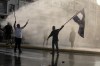 Greek police use tear gas and water cannons to disperse anti-vaccine protesters during a rally at Syntagma square, central Athens, on Wednesday, July 21, 2021. Thousands of people protested against Greek government's measures to curb rising COVID-19 infections and drive up vaccinations in the country where almost 50% of Greeks and country residents have received at least one dose of the vaccine. (AP Photo/Yorgos Karahalis)