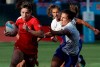 Canada's Ghislaine Landry, left, runs past France players during the Women's Rugby Sevens World Cup in San Francisco, Friday, July 20, 2018. THE CANADIAN PRESS/AP Photo-Jeff Chiu