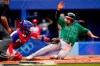 Mexico's Isaac Rodriguez, right, is tagged out at home plate by Dominican Republic's Charlie Valerio during a baseball game at Yokohama Baseball Stadium during the 2020 Summer Olympics, Friday, July 30, 2021, in Yokohama, Japan. (AP Photo/Matt Slocum)