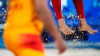 Feet and sand fly during the beach volleyball match between Norway and Spain at the 2020 Summer Olympics, Monday, July 26, 2021, in Tokyo, Japan. (AP Photo/Petros Giannakouris)