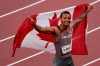 Canada's Andre De Grasse celebrates with the Canadian flag after racing to a gold medal in the Men's 200m final during the Tokyo Olympics in Tokyo, Japan on Wednesday, August 4, 2021. THE CANADIAN PRESS/Adrian Wyld