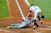 Los Angeles Angels' Juan Lagares (19) scores on a wild pitch by Texas Rangers relief pitcher Kolby Allard, right, who was unable to handle the high throw to the plate on the scoring play in the third inning of a baseball game in Arlington, Texas, Wednesday, Aug. 4, 2021. (AP Photo/Tony Gutierrez)