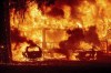 Flames consume a home on Highway 89 as the Dixie Fire tears through the Greenville community of Plumas County, Calif., on Wednesday, Aug. 4, 2021. The fire leveled multiple historic buildings and dozens of homes in central Greenville. (AP Photo/Noah Berger)