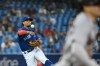 Toronto Blue Jays' Santiago Espinal, left, throws out Boston Red Sox Enrique Hernandez at first base in the third inning of game one of a double header American League baseball game in Toronto on Saturday Aug. 7, 2021. THE CANADIAN PRESS/Jon Blacker