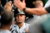 Chicago White Sox's Cesar Hernandez (12) celebrates with teammates in the dugout after hitting a solo home run during the eighth inning of a baseball game against the Chicago Cubs Saturday, Aug 7, 2021, at Wrigley Field in Chicago. (AP Photo/Paul Beaty)