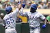 Texas Rangers' Adolis Garcia, right, celebrates with Yonny Hernandez (65) after hitting a two-run home run against the Oakland Athletics during the first inning of a baseball game in Oakland, Calif., Saturday, Aug. 7, 2021. (AP Photo/John Hefti)
