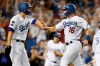 Los Angeles Dodgers' Corey Seager, left, and Will Smith celebrate after scoring on a double by Chris Taylor during the eighth inning of a baseball game against the Los Angeles Angels in Los Angeles, Saturday, Aug. 7, 2021. (AP Photo/Alex Gallardo)