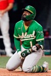 Oakland Athletics' Josh Harrison grimaces after getting hit by a pitch in the sixth inning of a baseball game against the Cleveland Indians, Tuesday, Aug. 10, 2021, in Cleveland. (AP Photo/Tony Dejak)