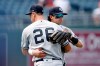 New York Yankees' DJ LeMahieu (26) and Tyler Wade, right, celebrate their team's 5-2 win at the end of a baseball game against the Kansas City Royals at Kauffman Stadium in Kansas City, Mo., Wednesday, Aug. 11, 2021. (AP Photo/Colin E. Braley)