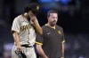 San Diego Padres starting pitcher Yu Darvish, left, leaves the game with Padres head athletic trainer Mark Rogow during the third inning of the team's baseball game against the Arizona Diamondbacks, Thursday, Aug. 12, 2021, in Phoenix. (AP Photo/Ross D. Franklin)