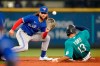 Toronto Blue Jays shortstop Bo Bichette, left, waits for the ball to tag out Seattle Mariners' Abraham Toro at second base to end the fourth inning of a baseball game Friday, Aug. 13, 2021, in Seattle. (AP Photo/Elaine Thompson)