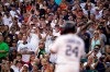 Baseball fans stand as Detroit Tigers' Miguel Cabrera comes up to bat during the third inning of a baseball game, Saturday, Aug. 14, 2021, in Detroit. (AP Photo/Carlos Osorio)