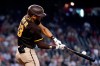 San Diego Padres' Fernando Tatis Jr. connects for a home run, his second of the baseball game, against the Arizona Diamondbacks during the fifth inning, Sunday, Aug. 15, 2021, in Phoenix. (AP Photo/Ross D. Franklin)