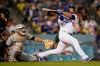 Los Angeles Dodgers' Max Muncy follows through on his solo home run during the eighth inning of a baseball game against the Pittsburgh Pirates Monday, Aug. 16, 2021, in Los Angeles. (AP Photo/Marcio Jose Sanchez)