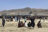 Hundreds of people gather near a U.S. Air Force C-17 transport plane at a perimeter at the international airport in Kabul, Afghanistan, Monday, Aug. 16, 2021. On Monday, the U.S. military and officials focus was on Kabul’s airport, where thousands of Afghans trapped by the sudden Taliban takeover rushed the tarmac and clung to U.S. military planes deployed to fly out staffers of the U.S. Embassy, which shut down Sunday, and others. (AP Photo/Shekib Rahmani)