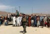 Hundreds of people gather outside the international airport in Kabul, Afghanistan, Tuesday, Aug. 17, 2021. The Taliban declared an “amnesty” across Afghanistan and urged women to join their government Tuesday, seeking to convince a wary population that they have changed a day after deadly chaos gripped the main airport as desperate crowds tried to flee the country. (AP Photo)