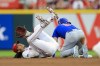 Cincinnati Reds' Jonathan India, left, lands on the ground after colliding with Chicago Cubs' Ian Happ, right, after throwing to first base to complete the double play during the third inning of a baseball game in Cincinnati, Tuesday, Aug. 17, 2021. (AP Photo/Aaron Doster)