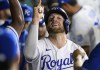 Kansas City Royals' Hunter Dozier celebrates his two-run home run with teammates during the seventh inning of a baseball game against the Houston Astros Wednesday, Aug. 18, 2021, in Kansas City, Mo. (AP Photo/Reed Hoffmann)