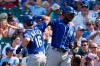 Kansas City Royals' Andrew Benintendi, left, celebrates with Michael A. Taylor after hitting a solo home run in the sixth inning of a baseball game against the Chicago Cubs, Friday, Aug. 20, 2021, in Chicago. (AP Photo/Nam Y. Huh)
