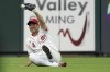 Cincinnati Reds left fielder Shogo Akiyama holds up his glove after catching a fly ball hit by Miami Marlins' Lewis Brinson to end the fifth inning of a baseball game Saturday, Aug. 21, 2021, in Cincinnati. (AP Photo/Jeff Dean)