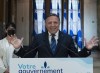 Quebec Premier François Legault gestures as he unveils his wish list to the leaders in the federal election, at his office in Quebec City, Thursday, Aug. 26, 2021. Quebec Treasury Board President Sonia Lebel, left, looks on. THE CANADIAN PRESS/Jacques Boissinot
