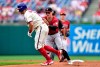 Philadelphia Phillies' J.T. Realmuto, left, is tagged out by Arizona Diamondbacks' Andrew Young after getting caught in a rundown during the third inning of a baseball game, Sunday, Aug. 29, 2021, in Philadelphia. (AP Photo/Derik Hamilton)