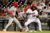 Philadelphia Phillies' Bryce Harper, left, is safe at first next to Washington Nationals first baseman Josh Bell (19) on a pick-off attempt during the third inning of a baseball game on Monday, Aug. 30, 2021, in Washington. (AP Photo/Nick Wass)