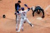 New York Mets' Javier Baez celebrates with Jonathan Villar after scoring the game winning run past Miami Marlins catcher Alex Jackson during the ninth inning of the first game of a baseball doubleheader that started April 11 and was suspended because of rain, Tuesday, Aug. 31, 2021, in New York. The Mets won 6-5. (AP Photo/Adam Hunger)