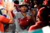 Philadelphia Phillies' Brad Miller is congratulated in the dugout for his two-run home run against the Washington Nationals during the ninth inning of a baseball game Tuesday, Aug. 31, 2021, in Washington. The Phillies won 12-6. (AP Photo/Nick Wass)
