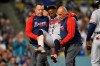 Atlanta Braves' Ozzie Albies is carried off the field after an injury during the fifth inning of the team's baseball game against the Los Angeles Dodgers on Tuesday, Aug. 31, 2021, in Los Angeles. (AP Photo/Marcio Jose Sanchez)