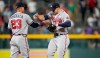 Atlanta Braves second baseman Ehire Adrianza, left, congratulates left fielder Adam Duvall after the ninth inning of a baseball game agtainst the Colorado Rockies Thursday, Sept. 2, 2021, in Denver. (AP Photo/David Zalubowski)