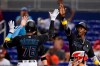 Miami Marlins' Jesus Sanchez (76) is congratulated by Jazz Chisholm Jr., right, and Miguel Rojas, left rear, after Sanchez hit a home run scoring the three during the first inning against the Philadelphia Phillies in a baseball game Friday, Sept. 3, 2021, in Miami. (AP Photo/Wilfredo Lee)