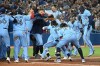 Toronto Blue Jays' Marcus Semien, centre, celebrates with teammates after hitting a three-run walk-off home run in the ninth inning of an American League baseball game against the Oakland Athletics in Toronto on Friday, Sept. 3, 2021. THE CANADIAN PRESS/Jon Blacker