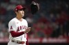 Los Angeles Angels starting pitcher Shohei Ohtani (17) tosses his glove as he returns to the dugout in the middle of the fourth inning of a baseball game against the Texas Rangers Friday, Sep. 3, 2021, in Anaheim, Calif. (AP Photo/Ashley Landis)