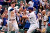 Chicago Cubs' Frank Schwindel, left, celebrates with Alfonso Rivas, center, after hitting the game-winning single as Pittsburgh Pirates catcher Jacob Stallings looks down in the ninth inning of a baseball game in Chicago, Saturday, Sept. 4, 2021. The Cubs won 7-6. (AP Photo/Nam Y. Huh)