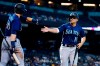 Seattle Mariners' Kyle Seager (15) celebrates his run scored against the Arizona Diamondbacks with teammate Jarred Kelenic (10) during the 11th inning of a baseball game Sunday, Sept. 5, 2021, in Phoenix. (AP Photo/Ross D. Franklin)
