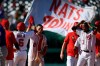 Washington Nationals' Carter Kieboom (8) high-fives Alex Avila (6) after hitting a walkoff single to drive in Josh Bell during the ninth inning of a baseball game against the New York Mets, Monday, Sept. 6, 2021, in Washington. Nationals' Alcides Escobar, right, looks on. (AP Photo/Nick Wass)