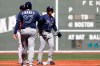 Tampa Bay Rays' Wander Franco smiles at third base coach Rodney Linares after he tripled against the Boston Red Sox during the first inning of a baseball game Monday, Sept. 6, 2021, at Fenway Park in Boston. (AP Photo/Winslow Townson)