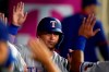 Texas Rangers' Yohel Pozo is high-fived in the dugout after scoring on a double by Jose Trevino during the seventh inning of a baseball game against the Los Angeles Angels Monday, Sept. 6, 2021, in Anaheim, Calif. (AP Photo/Marcio Jose Sanchez)