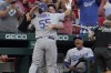 Los Angeles Dodgers' Albert Pujols (55) gets a hug from teammate Max Muncy after hitting a solo home run as Dodgers manager Dave Roberts, right, watches during the first inning of a baseball game against the St. Louis Cardinals Tuesday, Sept. 7, 2021, in St. Louis. (AP Photo/Jeff Roberson)