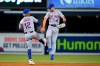 New York Mets shortstop Francisco Lindor (12) and center fielder Albert Almora Jr. (4) celebrate after the Mets defeated the Miami Marlins 9-4 in a baseball game Tuesday, Sept. 7, 2021, in Miami. (AP Photo/Wilfredo Lee)